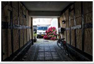 Another covered street entrance to housing.